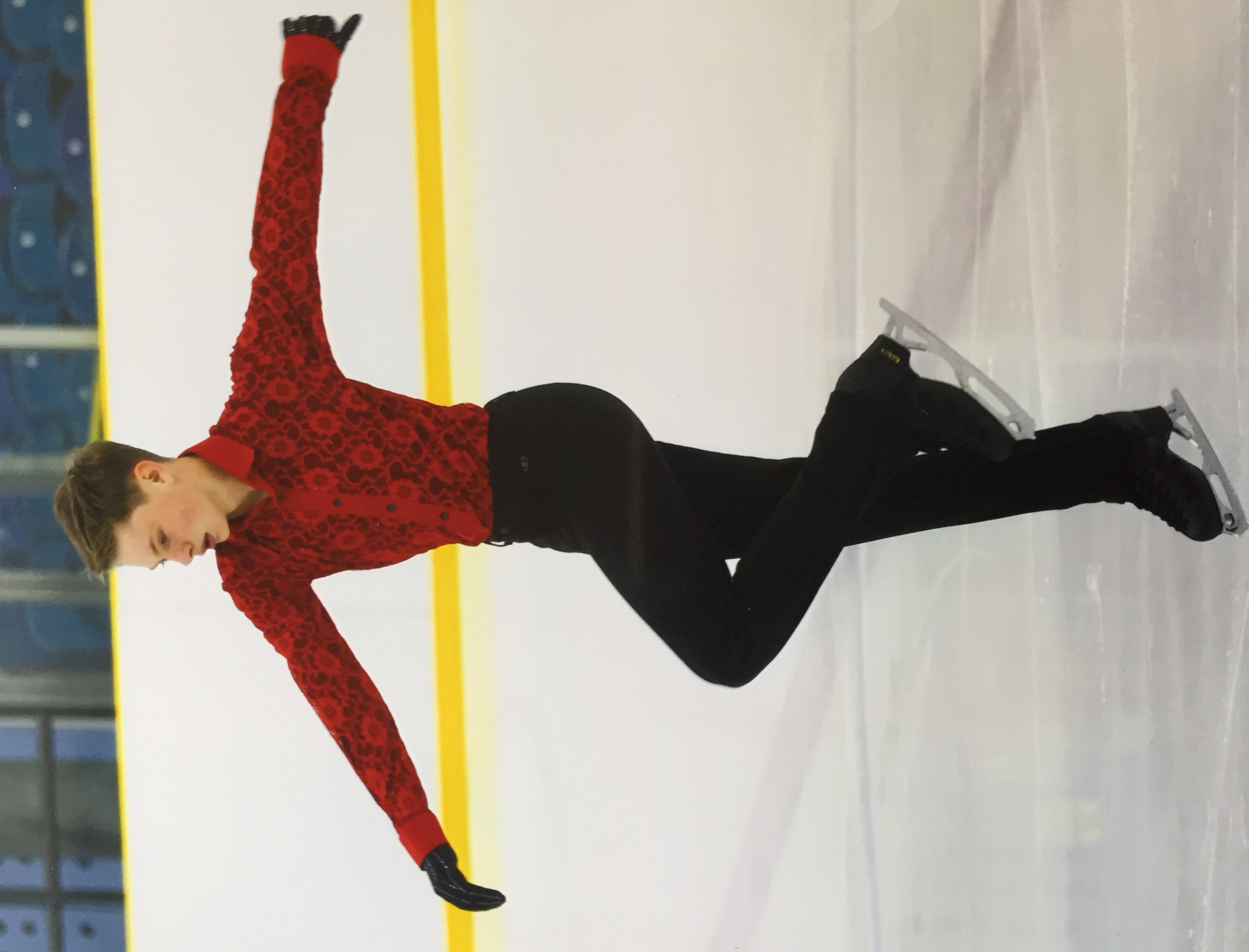Solo figure skater in red lace body shirt
